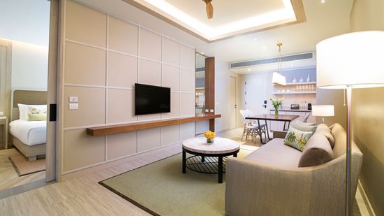 Flat-screen TV in living room in Club Amari Suite